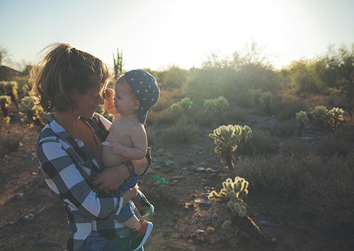 a woman holding a baby without sore joints